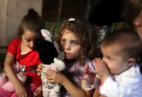 The daughters of Khaled al-Zeer al-Husaini, 39, sit at their father's cave in the east Jerusalem Arab neighbourhood of Silwan, Oct. 22, 2013. An Israeli court demanded family Silwan to stop the restoration work inside th...