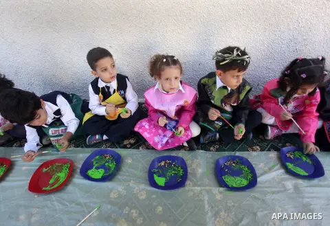 Palestinian school children color olives in Gaza city, on Oct. 24, 2013. as part of training children how to harvest olives. Regional farmers are harvesting their olives this year from mid-October until 01 Novembe. Photo...