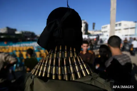 A Palestinian militant of Jihad Islamic movement takes part in a rally marking the 18th anniversary of the killing of Fathi al-Shiqaqi, the movement's founder, in Rafah in the southern Gaza Strip Oct. 24, 2013. al-Shiqaq...