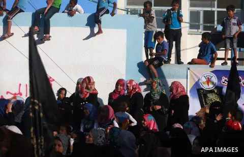 Palestinian supporters of Islamic Jihad movement attend a rally marking the 18th anniversary of the killing of Fathi al-Shiqaqi, the movement's founder, in Rafah in the southern Gaza Strip Oct. 24, 2013. al-Shiqaqi was s...