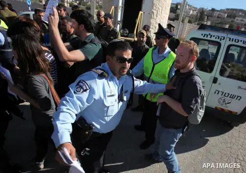 A protester is arrested as he was taking part in a protest against the arrival of thousands of Jewish visitors to the city, in the centre of the divided West Bank city of Hebron, 25 October 2013. Some of the protesters,...