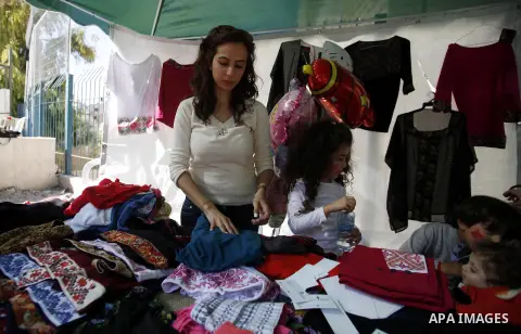 Palestinians take part in the annual Jerusalem's cakes festival in the east Jerusalem neighborhood of Sheikh Jarrah, Oct. 27, 2013. The Jerusalem's cakes festival is an annual carnival that inviting Palestinian children,...
