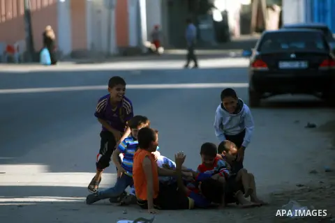 Palestinian children play outside their family homes in Rafah refugee camp in southern Gaza Strip, Oct. 27, 2013. The United Nations Relief and Works Agency for Palestine Refugees (UNRWA) has removed food aid for 9,558 f...