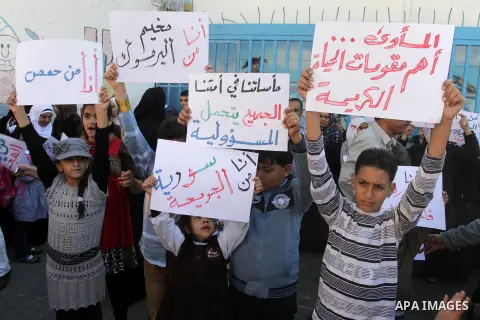 Syrian and Palestinian-Syrian refugees take part in a protest in front of the headquarters United Nations Relief and Works Agency (UNRWA) to demand assistance and work in Gaza city, on Oct. 28, 2013. Photo by Mohammed As...