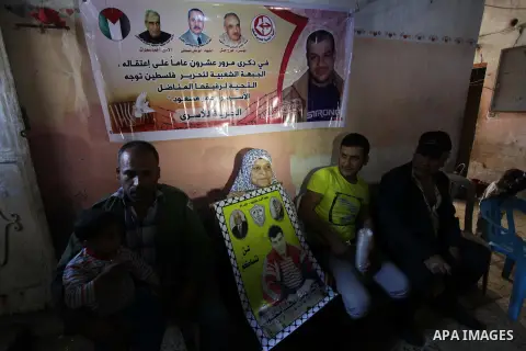 Relatives of Palestinian prisoner Omar Issa Massoud who has been held by Israel since 1993, celebrate after hearing news on his expected release, in Gaza City on Oct. 28, 2013. Israel has approved to release the second g...