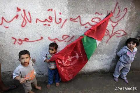 Relatives of Palestinian prisoner Omar Issa Massoud who has been held by Israel since 1993, celebrate after hearing news on his expected release, in Gaza City on Oct. 28, 2013. Israel has approved to release the second g...