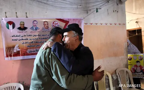 Relatives of Palestinian prisoner Omar Issa Massoud who has been held by Israel since 1993, celebrate after hearing news on his expected release, in Gaza City on Oct. 28, 2013. Israel has approved to release the second g...