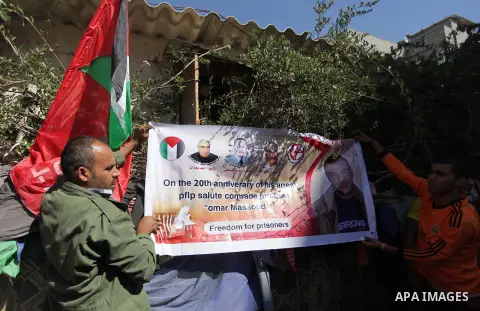 Relatives of Palestinian prisoner Omar Issa Massoud who has been held by Israel since 1993, celebrate after hearing news on his expected release, in Gaza City on Oct. 28, 2013. Israel has approved to release the second g...