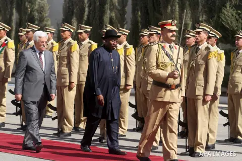 Palestinian President Mahmoud Abbas, and Nigerian President Goodluck Jonathan walk past an honor guard during a welcoming ceremony in the West Bank city of Ramallah, Tuesday, Oct. 29, 2013. Photo by Issam Rimawi