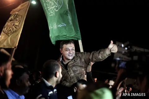 A released Palestinian prisoner is greeted by people upon his arrival at Erez crossing between Israel and northern Gaza Strip October 30, 2013. Israel freed 26 Palestinian prisoners on Wednesday, the second stage of a li...