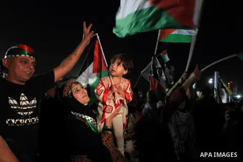 Palestinian families and friends celebrate as they gather outside the headquarters of president Mahmud Abbas for the release of some 26 prisoners from Israeli jails, in the West Bank city of Ramallah, on October 29, 2013...