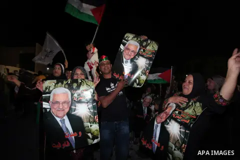 Palestinian families and friends celebrate as they gather outside the headquarters of president Mahmud Abbas for the release of some 26 prisoners from Israeli jails, in the West Bank city of Ramallah, on October 29, 2013...