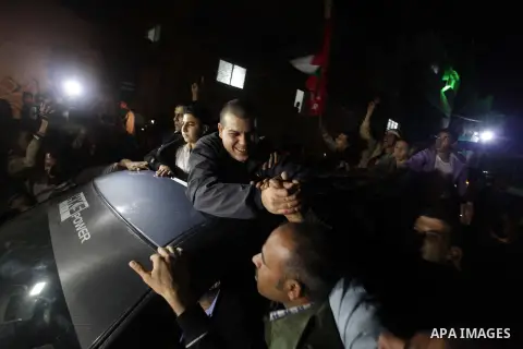 A released Palestinian prisoner is greeted by people upon his arrival at Erez crossing between Israel and northern Gaza Strip October 30, 2013. Israel freed 26 Palestinian prisoners on Wednesday, the second stage of a li...
