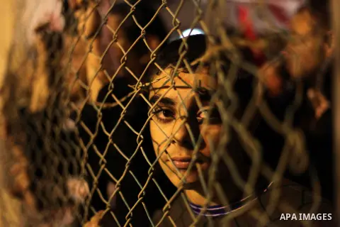 Palestinian prisoners' relatives wait for their release at Erez crossing in the northern Gaza Strip on October 29, 2013. Israel was preparing on October 29, 2013 to release 26 long-serving Palestinian prisoners, the seco...