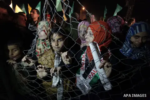 Palestinian prisoners' relatives wait for their release at Erez crossing in the northern Gaza Strip on October 29, 2013. Israel was preparing on October 29, 2013 to release 26 long-serving Palestinian prisoners, the seco...