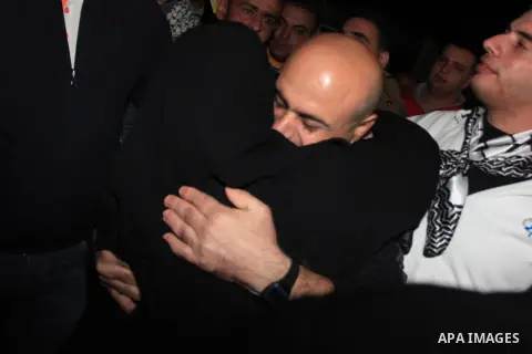 A released Palestinian prisoner coming from an Israeli jail is welcomed by his family members as he arrives at Palestinian President Mahmoud Abbas' headquarters in the West Bank town of Ramallah, West Bank, 30 October 20...