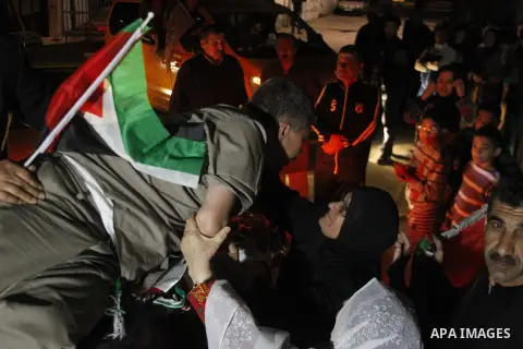 Palestinian prisoner Najeh Meqbel is welcomed by family members after he was released from am Isreali prison, in the al-Aroub refugee camp, just north of the West Bank town of Hebron, 30 October 2013. Palestinian Preside...