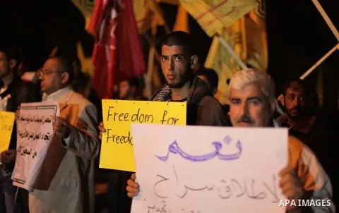Palestinian prisoners' relatives wait for their release at Erez crossing in the northern Gaza Strip on October 29, 2013. Israel was preparing on October 29, 2013 to release 26 long-serving Palestinian prisoners, the seco...