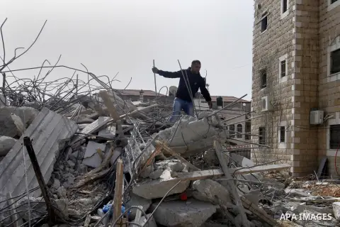 A Palestinian man collects his belongings after his house was demolished by Israeli bulldozers in the East Jerusalem neighbourhood of Beit Hanina, which falls in the West Bank side of Israel's separation barrier on Oct....