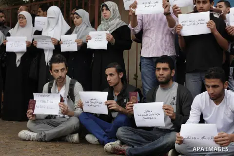 Palestinian protesters hold placards during a demonstration in front of United Nation building in Gaza City to mark the anniversary of the Balfour Declaration on October 31, 2013. The 1917 Balfour Declaration is a formal...