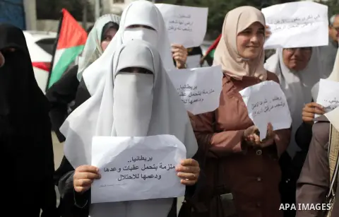 Palestinian protesters hold placards during a demonstration in Gaza City to mark the anniversary of the Balfour Declaration on October 31, 2013. The 1917 Balfour Declaration is a formal statement of policy by the British...