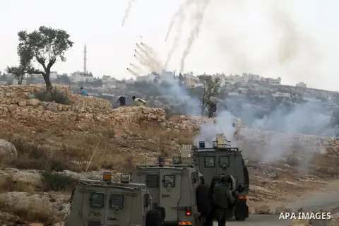 Israeli security forces fire tear gas towards Palestinian protester during clashes after a demonstration against Israel's separation barrier and in solidarity with Palestinian prisoners being held in Israeli jails, in th...