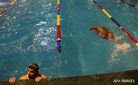 Palestinians wounded participate a local swimming competition for wounded Palestinians at al-Sadaka Club in Gaza City November 2, 2013. The competition was organised for wounded Palestinians in an attempt to help them ge...