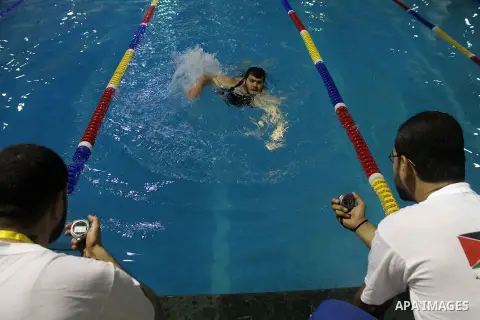 Palestinians wounded participate a local swimming competition for wounded Palestinians at al-Sadaka Club in Gaza City November 2, 2013. The competition was organised for wounded Palestinians in an attempt to help them ge...