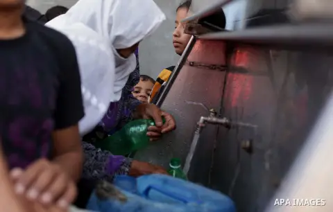 Palestinian children fill their bottles a potable water at a water purification station, in Deir al-Balah central Gaza Strip, on Nov. 05. 2013. Palestinians suffer from the severe lack of potable water. Photo by Ashraf A...