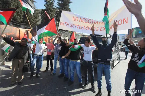 Palestinian protesters hold flags and a banner during a demonstration against the visit of the US Secretary of State John Kerry and peace negotiations, in the West Bank city of Bethlehem, 06 November 2013. Kerry began a...