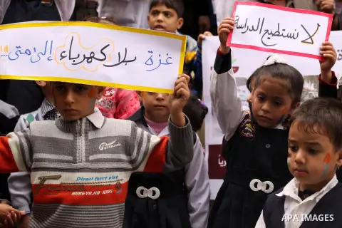 Palestinian students hold banners during a protest against the severe fuel cuts that lead to power shortages and the siege, in Gaza city, November 09, 2013. Gaza's lone power plant shut its generators on Friday due to a...