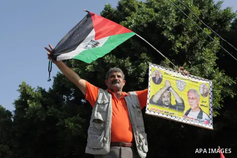 Supporters of the Popular Front for the Liberation of Palestine (PFLP) hold placards during a protest in solidarity with Palestinian prisoners in Israeli jails, in front of high commissioner for human rights headquarters...