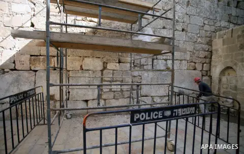 A laborer of Israeli Antiquities Authority works on a wall in entrance of Shihabi neighborhood next to the Al-Aqsa Mosque, in Jerusalem's Old City on November 11, 2013. Israeli Antiquities Authority intends to transform...