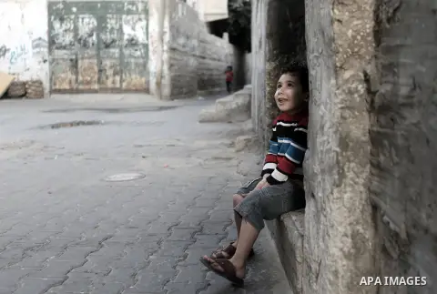 A Palestinian girl plays outside her family's home in Rafah refugee camp in southern Gaza Strip, Nov. 11, 2013. The United Nations Relief and Works Agency for Palestine Refugees (UNRWA) has removed food aid for 9,558 fam...