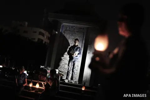 Palestinian school boys study on kerosene lanterns during a protest against the severe fuel cuts that lead to power shortages and the siege in Gaza City on November 12, 2013. Gaza is left dependent on electricity purchas...