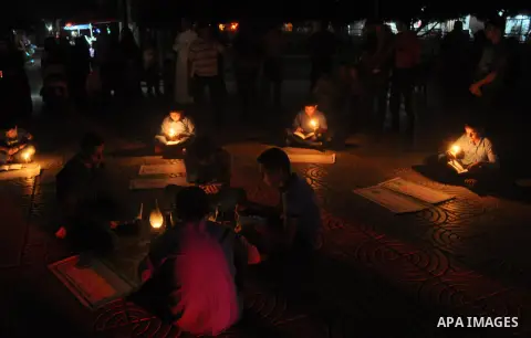 Palestinian school boys study on kerosene lanterns and candles light during a protest against the severe fuel cuts that lead to power shortages and the siege in Gaza City on November 12, 2013. Gaza is left dependent on e...