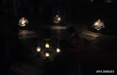 Palestinian school boys study on kerosene lanterns and candles light during a protest against the severe fuel cuts that lead to power shortages and the siege in Gaza City on November 12, 2013. Gaza is left dependent on e...