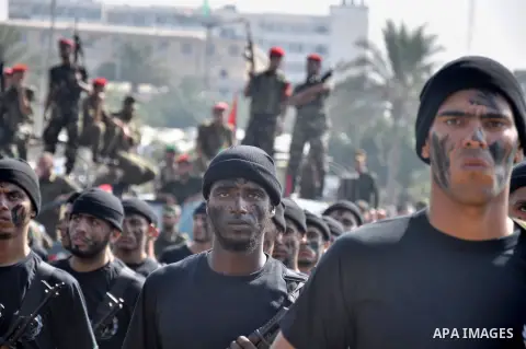 Members of the Palestinian security forces march along the streets in Gaza City on November 13, 2013, ahead of the first anniversary an Israeli army operation which was launched after the killing of top Palestinian milit...