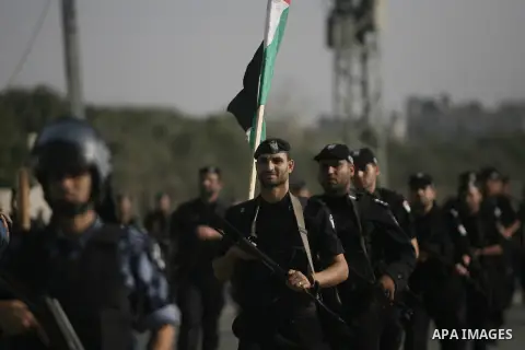 Members of the Palestinian security forces march along the streets in Rafah in southern Gaza strip on November 13, 2013, ahead of the first anniversary an Israeli army operation which was launched after the killing of to...
