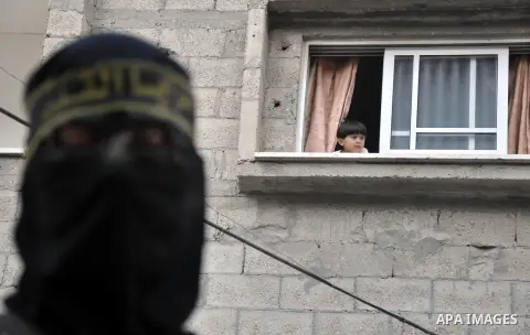 Members of al-Quds brigades, the military wing of Jihad Islamic organisation march along the streets in Gaza City on November 13, 2013, ahead of the first anniversary an Israeli army operation which was launched after th...