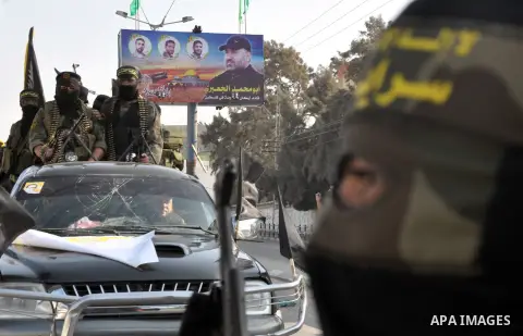 Members of al-Quds brigades, the military wing of Jihad Islamic organisation march along the streets in Gaza City on November 13, 2013, ahead of the first anniversary an Israeli army operation which was launched after th...