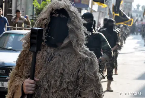 Members of al-Quds brigades, the military wing of Jihad Islamic organisation march along the streets in Gaza City on November 13, 2013, ahead of the first anniversary an Israeli army operation which was launched after th...