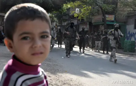 Members of al-Quds brigades, the military wing of Jihad Islamic organisation march along the streets in Gaza City on November 13, 2013, ahead of the first anniversary an Israeli army operation which was launched after th...