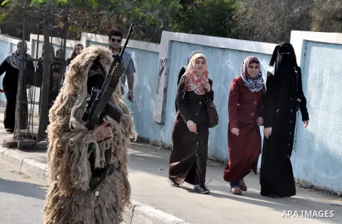 Members of al-Quds brigades, the military wing of Jihad Islamic organisation march along the streets in Gaza City on November 13, 2013, ahead of the first anniversary an Israeli army operation which was launched after th...