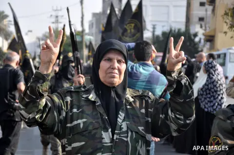 Members of al-Quds brigades, the military wing of Jihad Islamic organisation march along the streets in Gaza City on November 13, 2013, ahead of the first anniversary an Israeli army operation which was launched after th...
