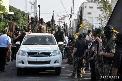 Members of al-Quds brigades, the military wing of Jihad Islamic organisation march along the streets in Gaza City on November 13, 2013, ahead of the first anniversary an Israeli army operation which was launched after th...