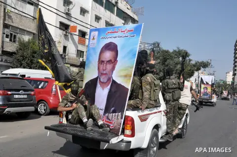Members of al-Quds brigades, the military wing of Jihad Islamic organisation march along the streets in Gaza City on November 13, 2013, ahead of the first anniversary an Israeli army operation which was launched after th...