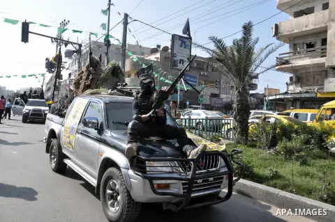 Members of al-Quds brigades, the military wing of Jihad Islamic organisation march along the streets in Gaza City on November 13, 2013, ahead of the first anniversary an Israeli army operation which was launched after th...
