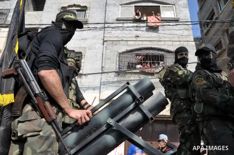 Members of al-Quds brigades, the military wing of Jihad Islamic organisation march along the streets in Gaza City on November 13, 2013, ahead of the first anniversary an Israeli army operation which was launched after th...