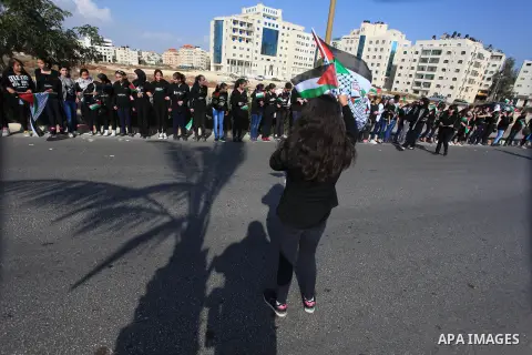 Palestinian protesters hold placards and flags during a demonstration in solidarity with Palestinian prisoners in Israeli jails, in the West Bank City of Ramallah, November 13, 2013. A human rights report said on Tuesday...